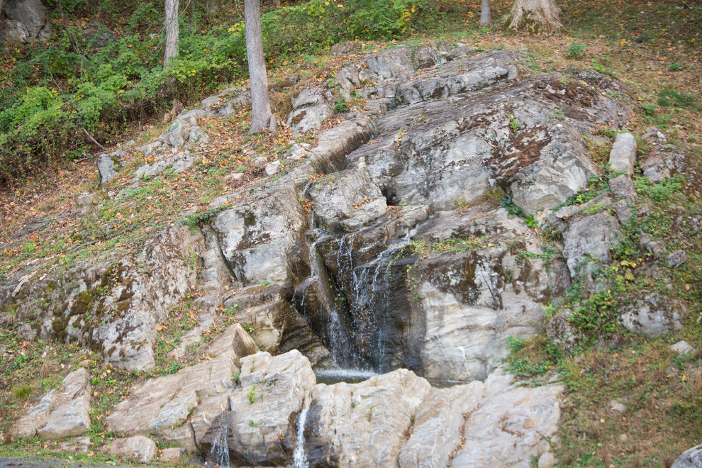 Photo of a small rustic partial sun backyard water fountain landscape in DC Metro.