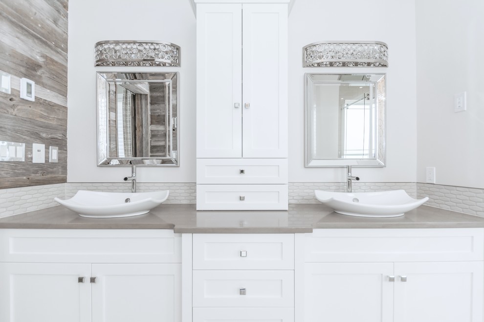 Inspiration for a large transitional master gray tile and ceramic tile porcelain tile freestanding bathtub remodel in Toronto with a vessel sink, white cabinets, quartz countertops and white walls
