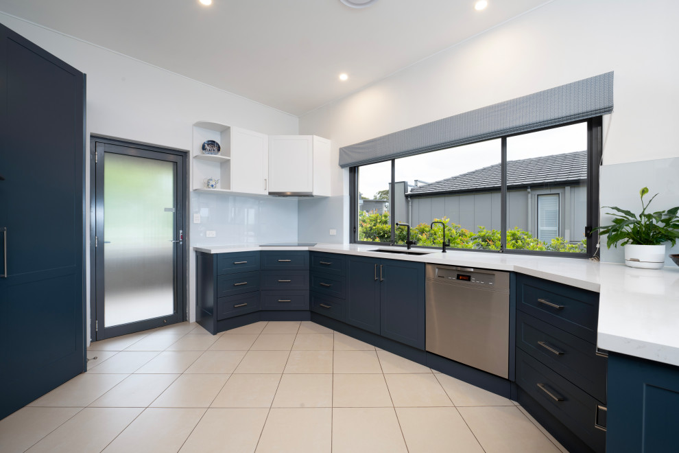 This is an example of a mid-sized modern u-shaped kitchen pantry in Sydney with shaker cabinets, blue cabinets, quartz benchtops, blue splashback and white benchtop.