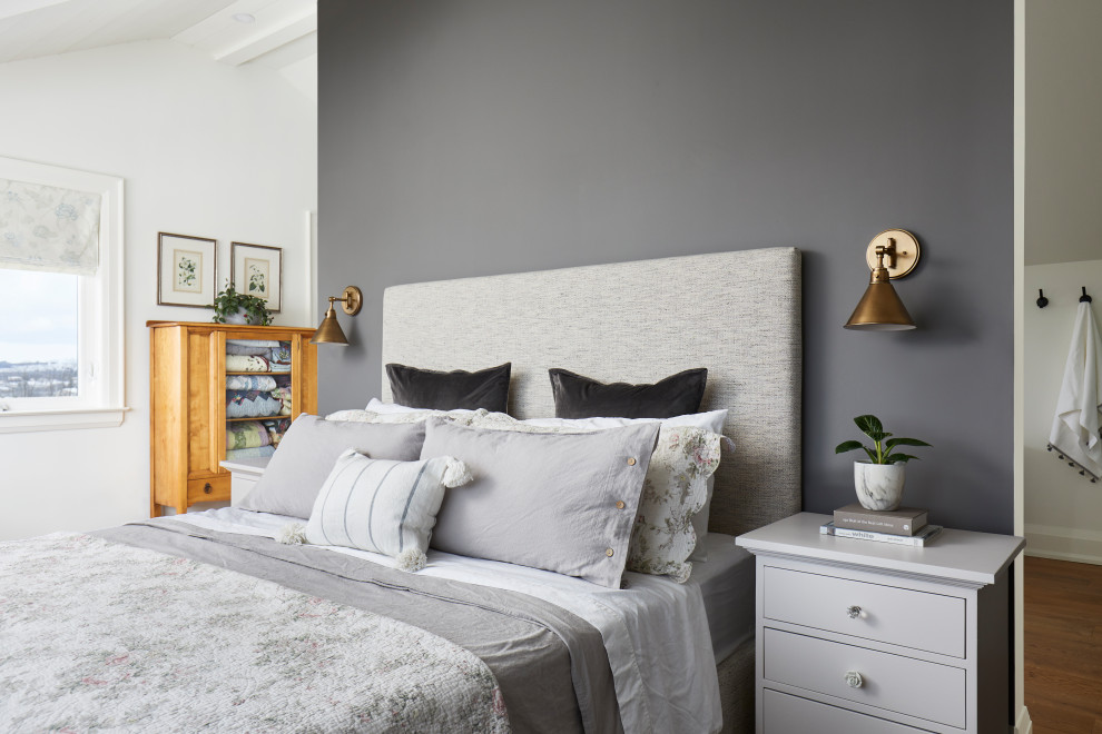 This is an example of a medium sized rural master and grey and white bedroom in Toronto with grey walls, medium hardwood flooring, brown floors and a feature wall.