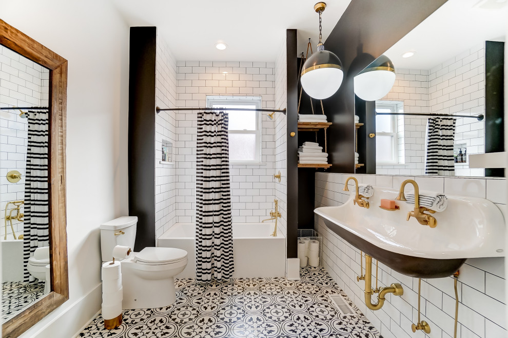 This is an example of a transitional 3/4 bathroom in Columbus with an alcove tub, white tile, subway tile, black walls, a wall-mount sink, multi-coloured floor and a double vanity.