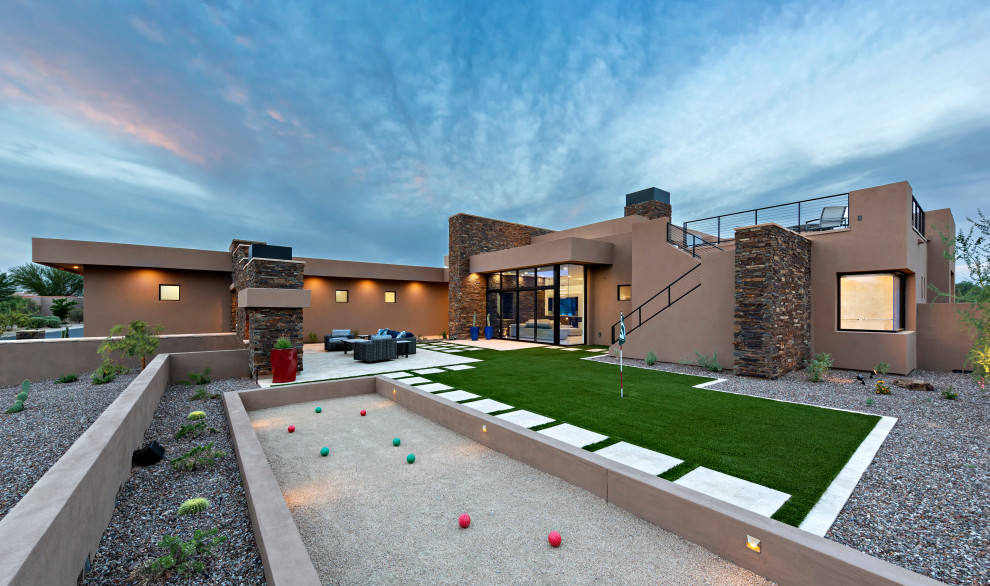 Contemporary backyard full sun outdoor sport court in Phoenix with gravel.