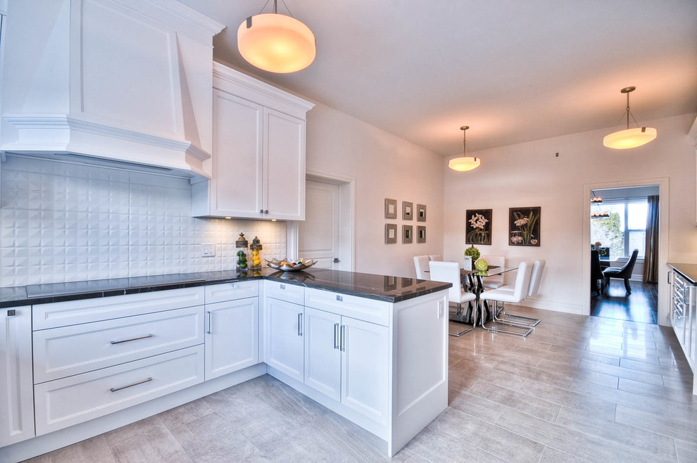 Example of a mid-sized transitional u-shaped porcelain tile enclosed kitchen design in Ottawa with a drop-in sink, shaker cabinets, white cabinets, marble countertops, white backsplash, porcelain backsplash, stainless steel appliances and no island