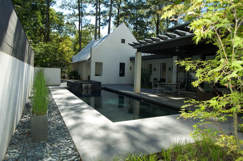Inspiration for a modern backyard rectangular pool in Atlanta with stamped concrete.