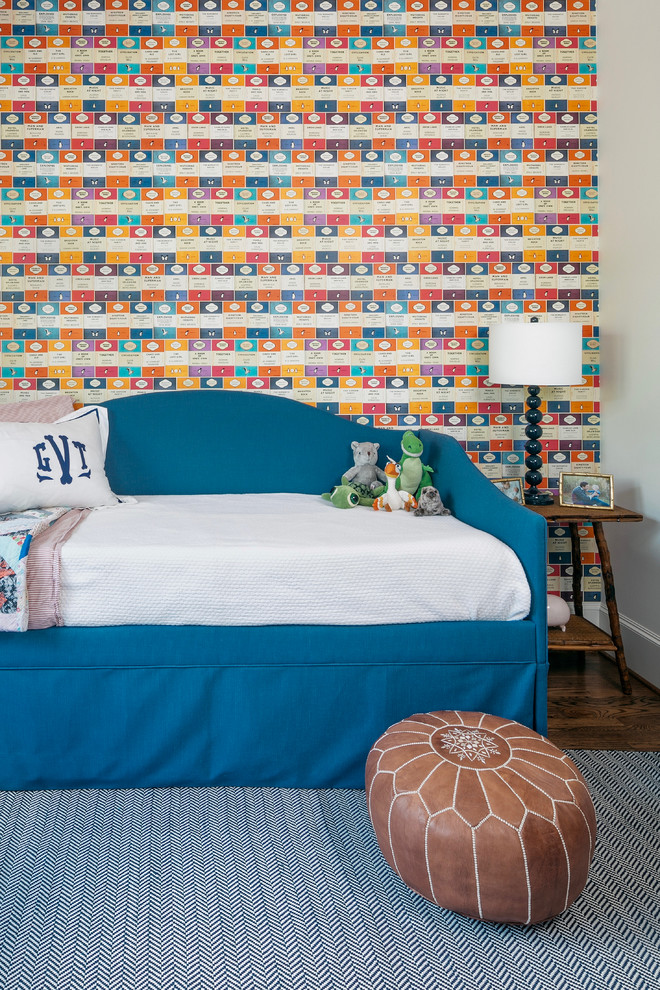 This is an example of an expansive arts and crafts gender-neutral kids' bedroom for kids 4-10 years old in Houston with multi-coloured walls, dark hardwood floors and wallpaper.