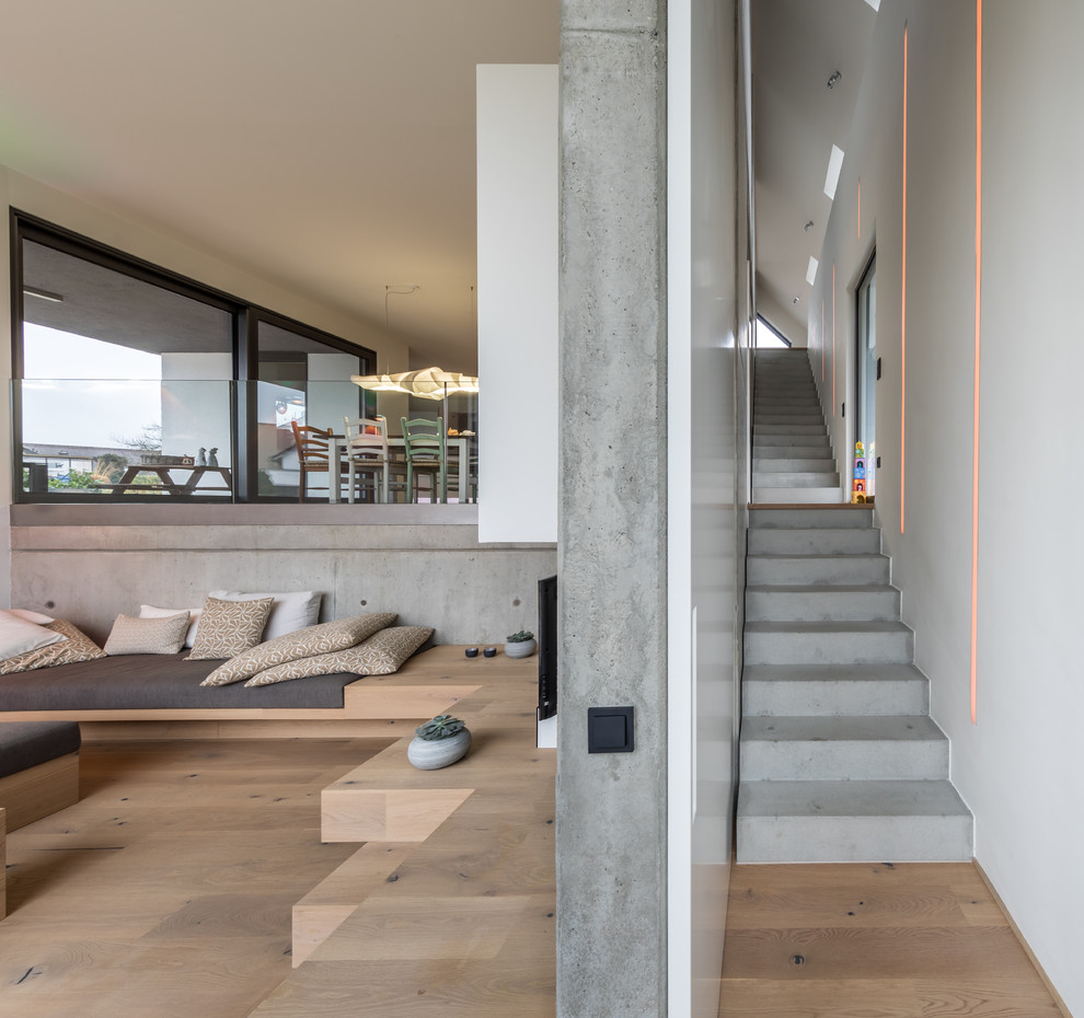 Inspiration for an expansive contemporary concrete straight staircase in Other with concrete risers.