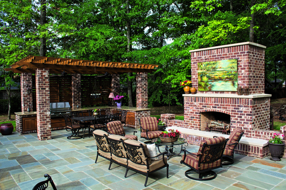 Large traditional backyard patio in Jackson with a fire feature, natural stone pavers and no cover.