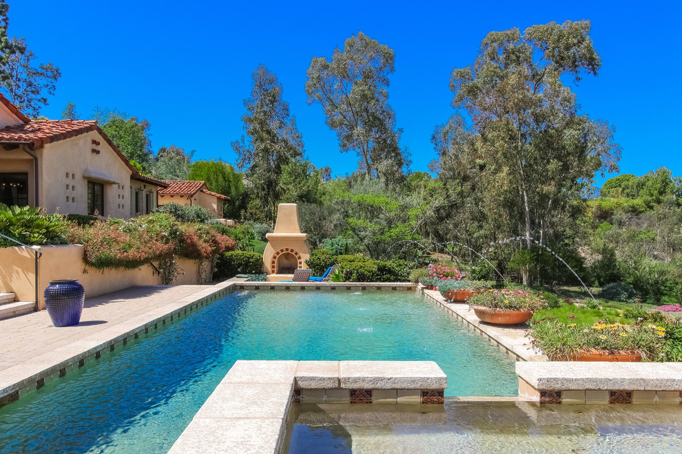 Design ideas for a mediterranean rectangular pool in San Diego with a water feature.