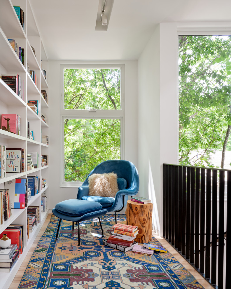 1960s light wood floor and beige floor family room library photo in Austin with white walls