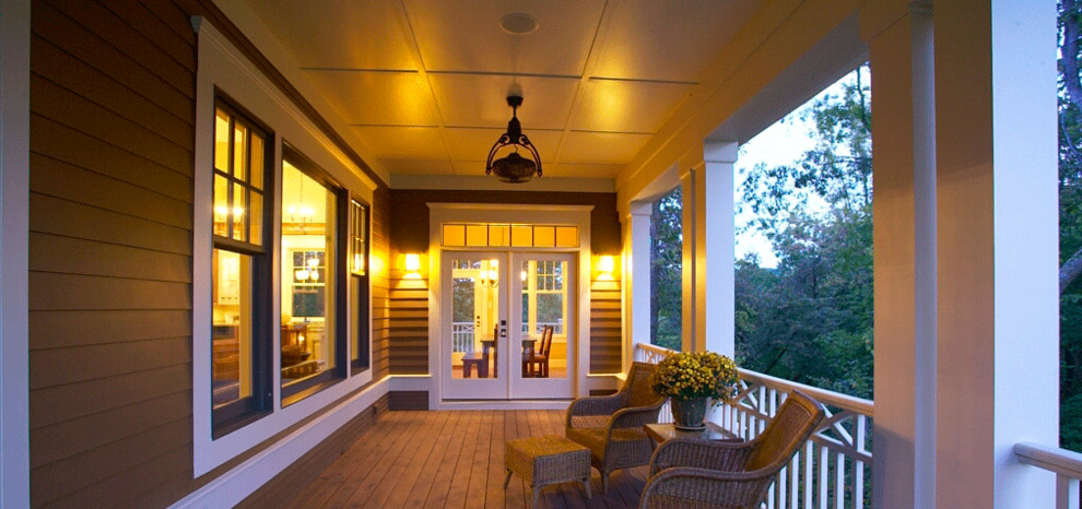 Mid-sized transitional patio photo in Cedar Rapids with decking and a roof extension