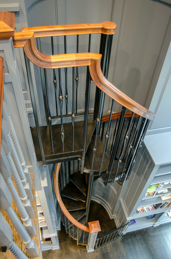 This is an example of a classic wood spiral staircase in Boston with wood risers.