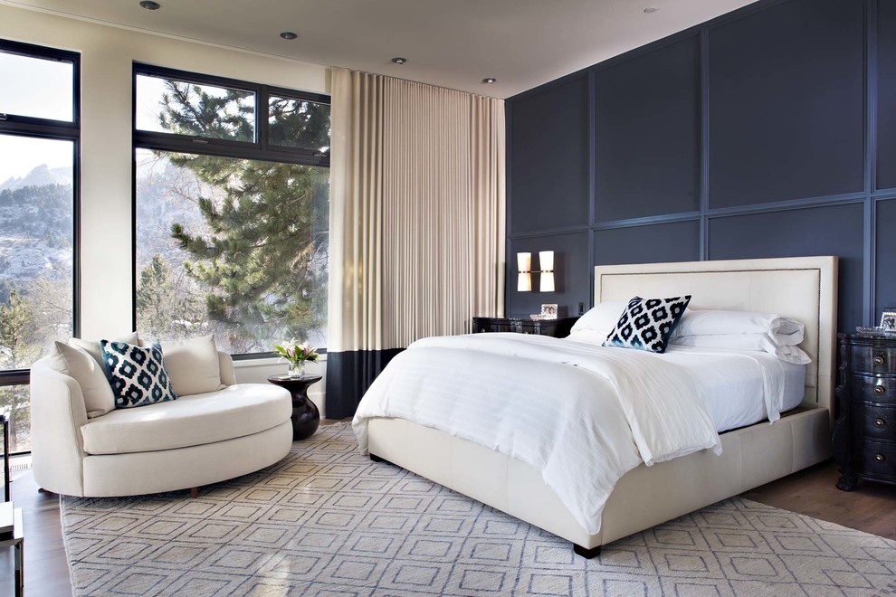 Design ideas for a transitional bedroom in Denver with black walls, medium hardwood floors and brown floor.