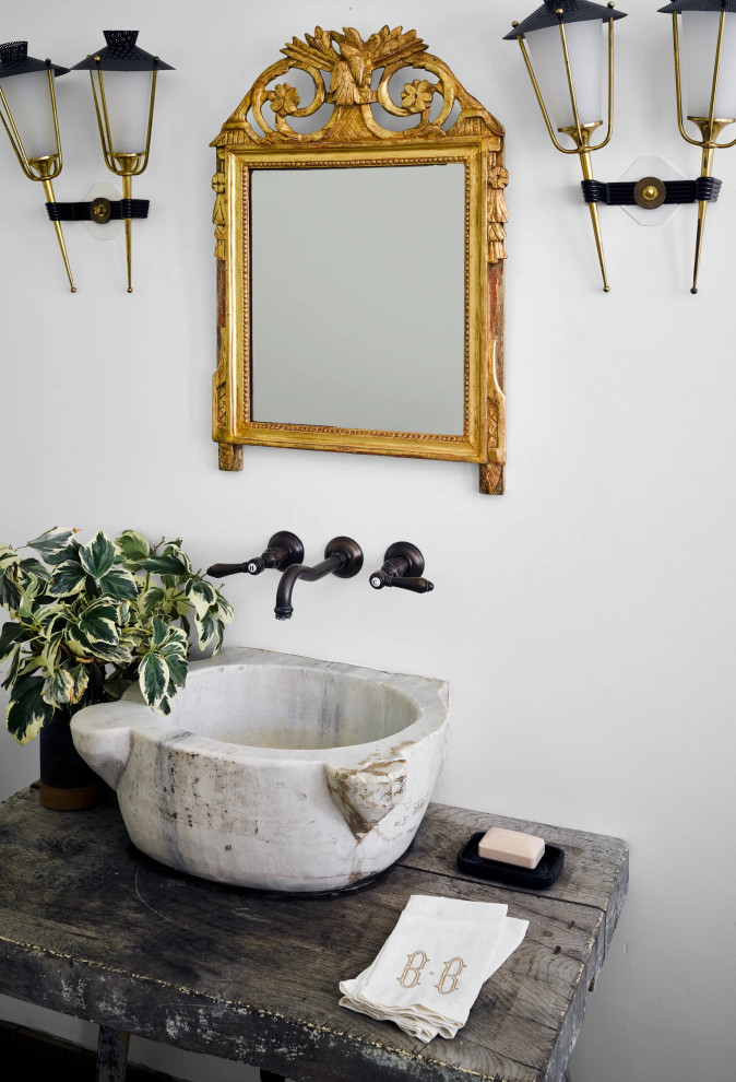 Inspiration for a small country powder room in Los Angeles with open cabinets, a vessel sink and a freestanding vanity.