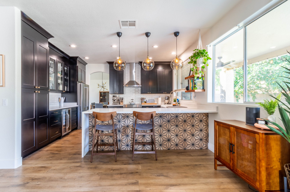 Example of a large 1960s kitchen design in Phoenix with a farmhouse sink, shaker cabinets, dark wood cabinets, quartz countertops, white backsplash, subway tile backsplash, stainless steel appliances and white countertops