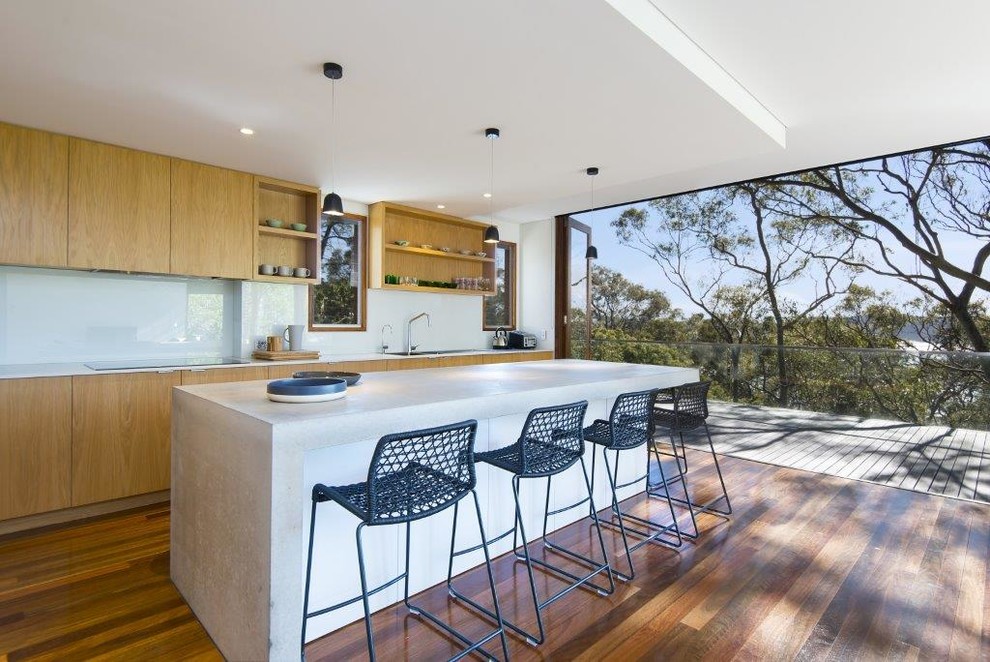 Photo of a contemporary kitchen in Sydney with beaded inset cabinets, medium wood cabinets, glass sheet splashback, dark hardwood floors and brown floor.