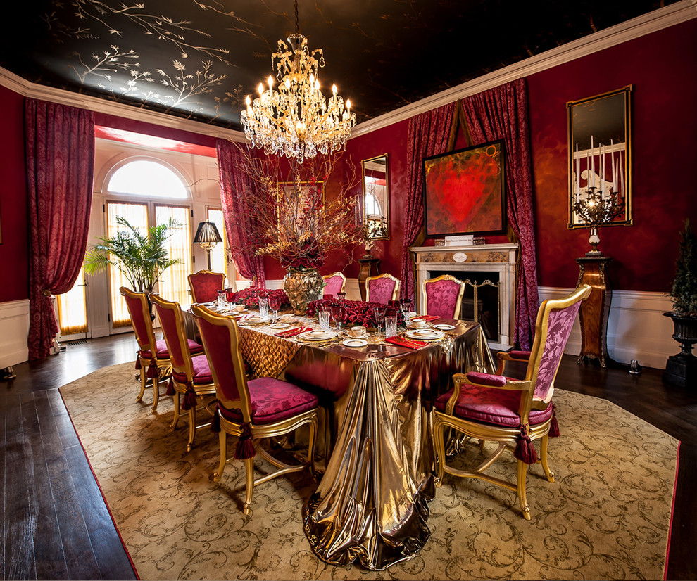 Large traditional separate dining room in New York with red walls, dark hardwood floors, a standard fireplace, a concrete fireplace surround and brown floor.