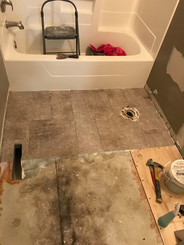 Small trendy vinyl floor and gray floor bathroom photo in Minneapolis with shaker cabinets, white cabinets, gray walls, an integrated sink and solid surface countertops