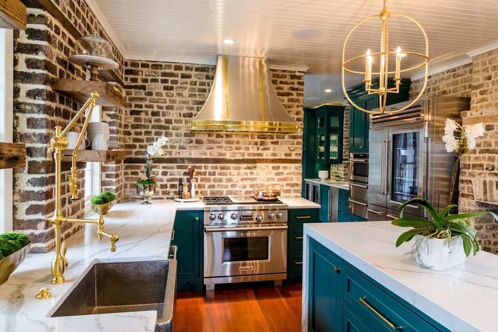 Photo of a mid-sized transitional kitchen pantry in Charleston with a farmhouse sink, beaded inset cabinets, green cabinets, quartz benchtops, brown splashback, brick splashback, stainless steel appliances, medium hardwood floors, with island, brown floor and white benchtop.
