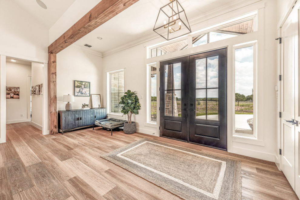 Example of a mid-sized transitional vinyl floor and exposed beam foyer design in Dallas with white walls and a black front door