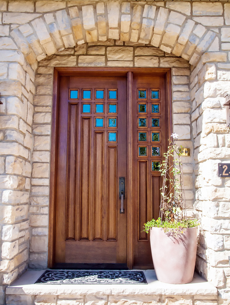 Small arts and crafts front door in Other with concrete floors, a single front door and a brown front door.