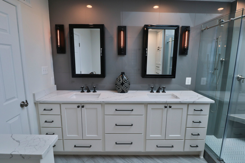 Inspiration for a mid-sized transitional 3/4 bathroom with shaker cabinets, white cabinets, an alcove shower, grey walls, vinyl floors, an undermount sink, marble benchtops, grey floor, a hinged shower door and white benchtops.