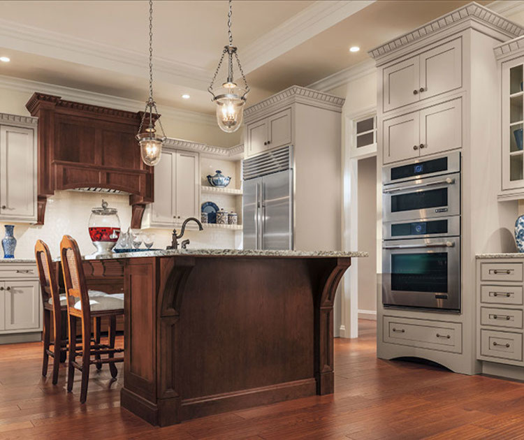Mid-sized transitional l-shaped dark wood floor and brown floor eat-in kitchen photo in Orange County with an undermount sink, white cabinets, granite countertops, beige backsplash, ceramic backsplash, stainless steel appliances, an island and recessed-panel cabinets