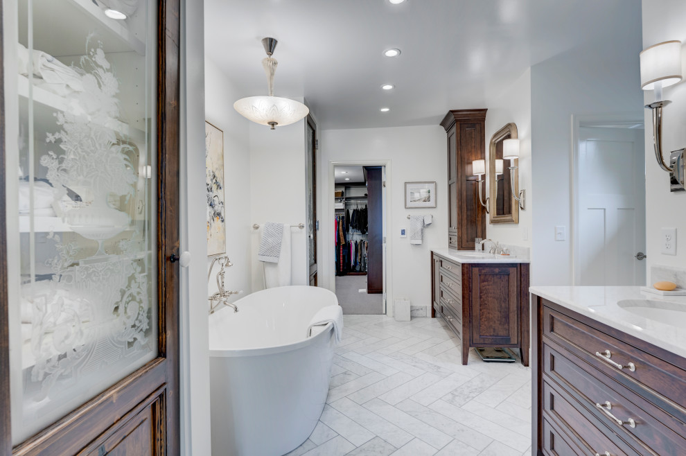 Inspiration for a large traditional master bathroom in Denver with beaded inset cabinets, dark wood cabinets, a freestanding tub, white walls, an undermount sink, a single vanity and a built-in vanity.
