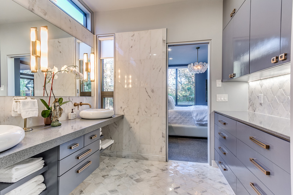 Inspiration for a mid-sized contemporary master bathroom in Oklahoma City with flat-panel cabinets, blue cabinets, gray tile, grey walls, marble floors, a vessel sink, marble, engineered quartz benchtops and multi-coloured floor.