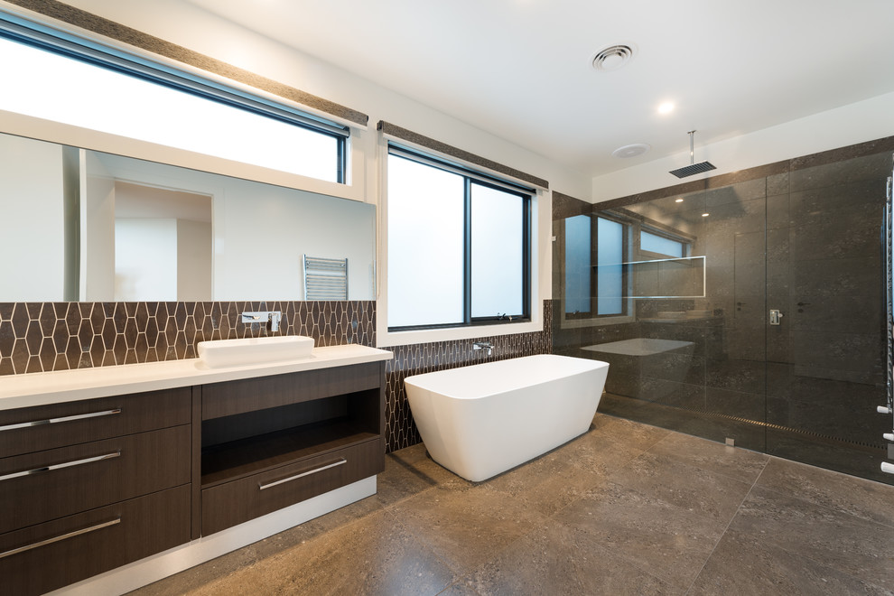 This is an example of a contemporary kids bathroom in Melbourne with a freestanding tub, a double shower, gray tile, porcelain tile, white walls, porcelain floors, a vessel sink and engineered quartz benchtops.