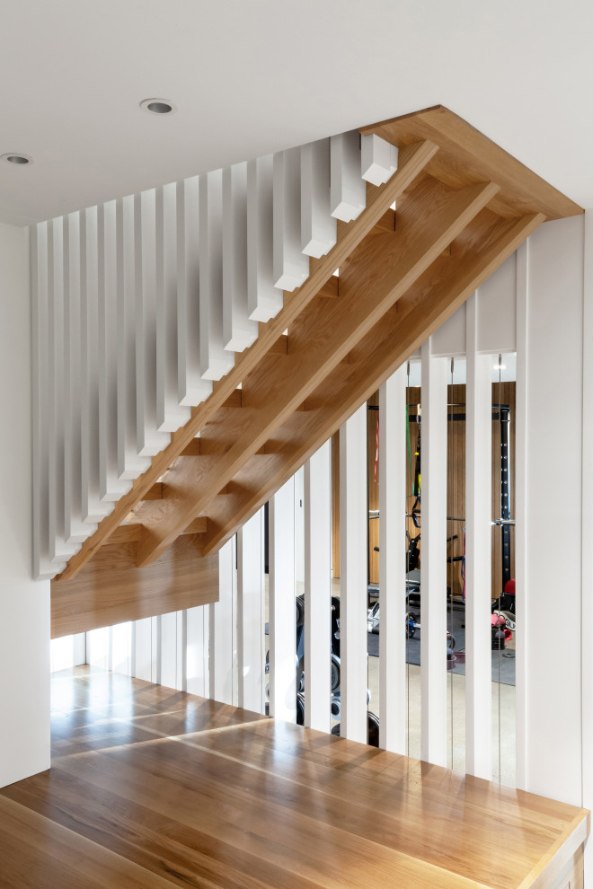 Inspiration pour un escalier sans contremarche nordique en L de taille moyenne avec des marches en bois et un garde-corps en bois.