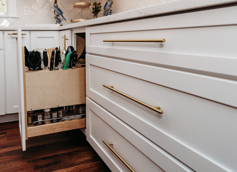 Mid-sized transitional galley brown floor and medium tone wood floor eat-in kitchen photo in Baltimore with shaker cabinets, white cabinets, quartz countertops, white backsplash, subway tile backsplash, stainless steel appliances, an island, white countertops and an undermount sink