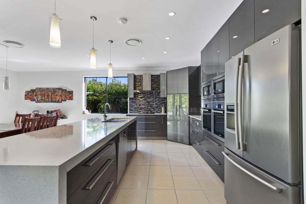 Design ideas for a modern kitchen in Gold Coast - Tweed with a double-bowl sink, grey cabinets, multi-coloured splashback, ceramic splashback, stainless steel appliances, with island, white benchtop, porcelain floors and yellow floor.