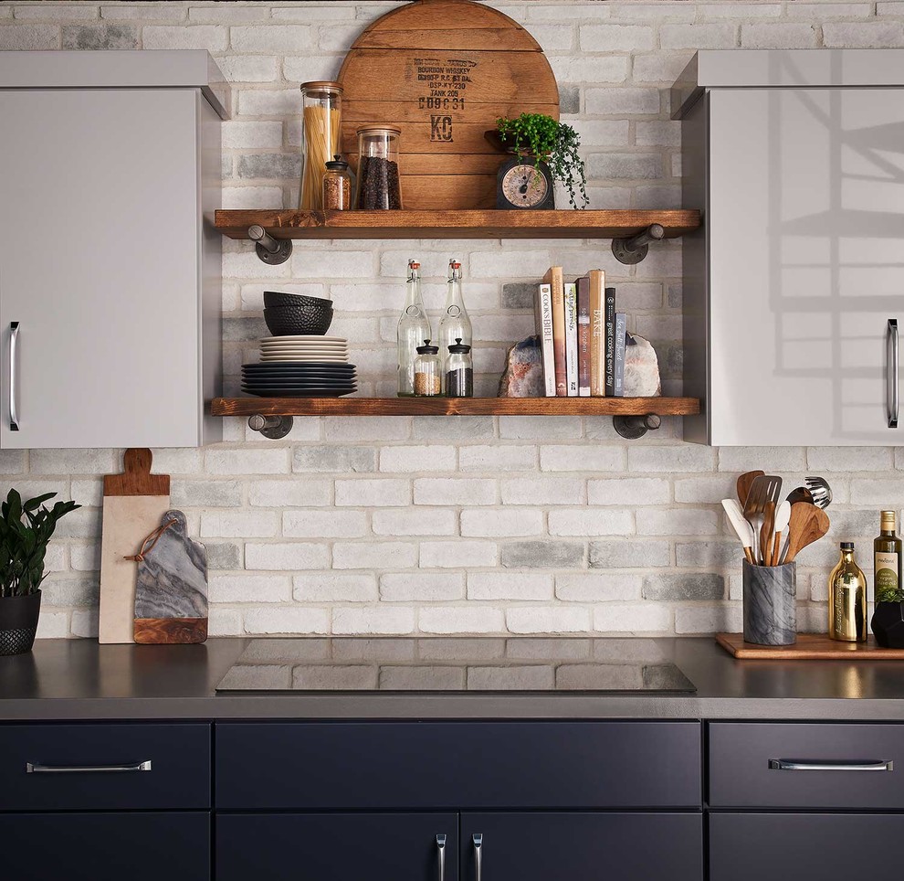 Inspiration for a mid-sized industrial single-wall eat-in kitchen in San Diego with an undermount sink, flat-panel cabinets, grey cabinets, white splashback, brick splashback, stainless steel appliances, with island and beige floor.
