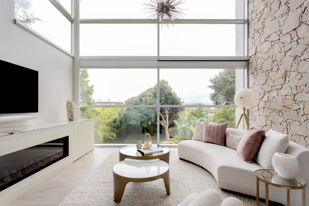 Photo of a midcentury living room in Melbourne with white walls, a ribbon fireplace, a wall-mounted tv and beige floor.