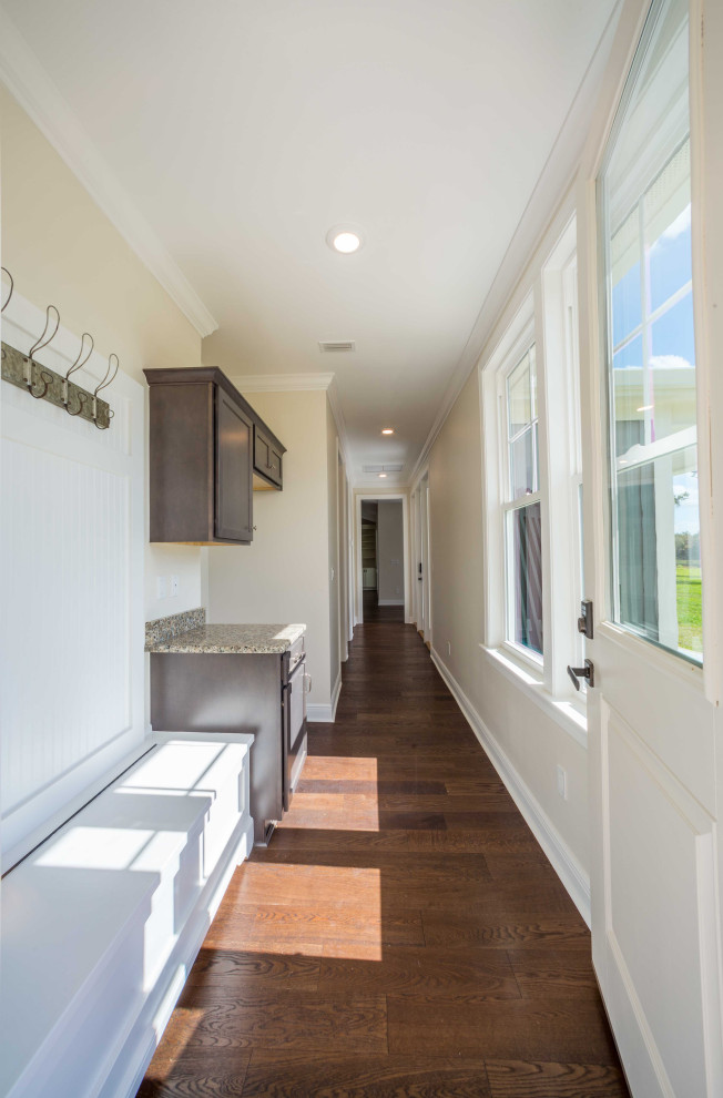 Inspiration for a mid-sized timeless medium tone wood floor and brown floor hallway remodel with beige walls