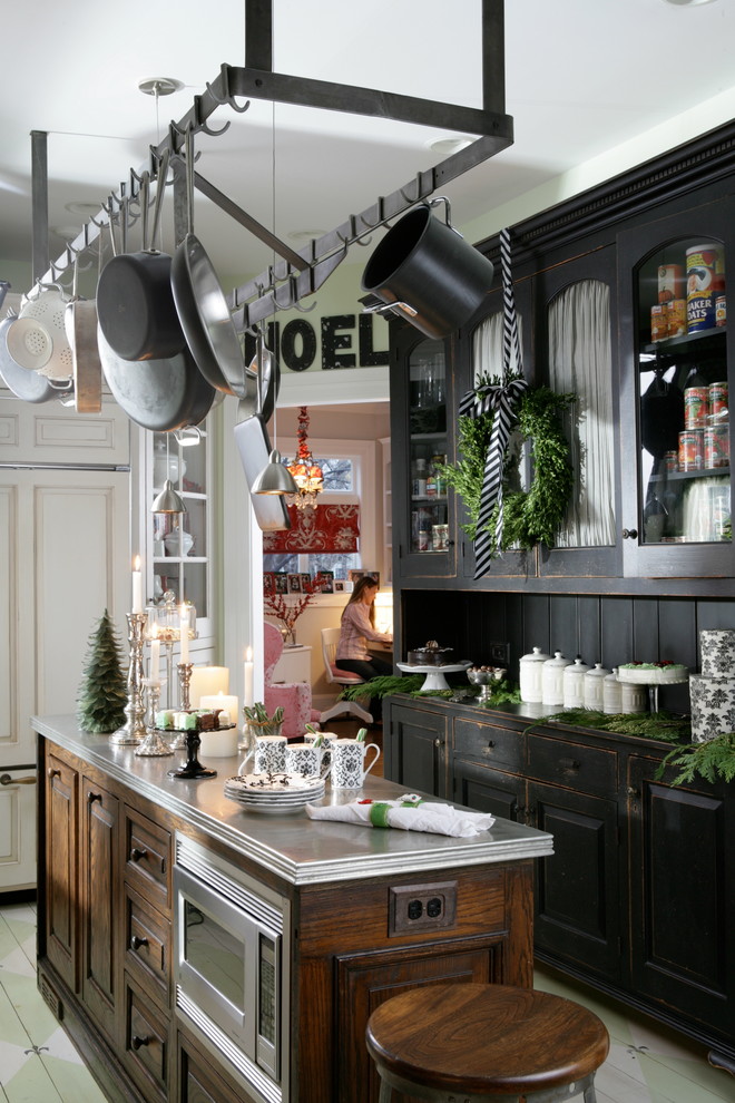 Inspiration for a traditional l-shaped separate kitchen in Chicago with distressed cabinets, painted wood floors, with island, black splashback and stainless steel appliances.