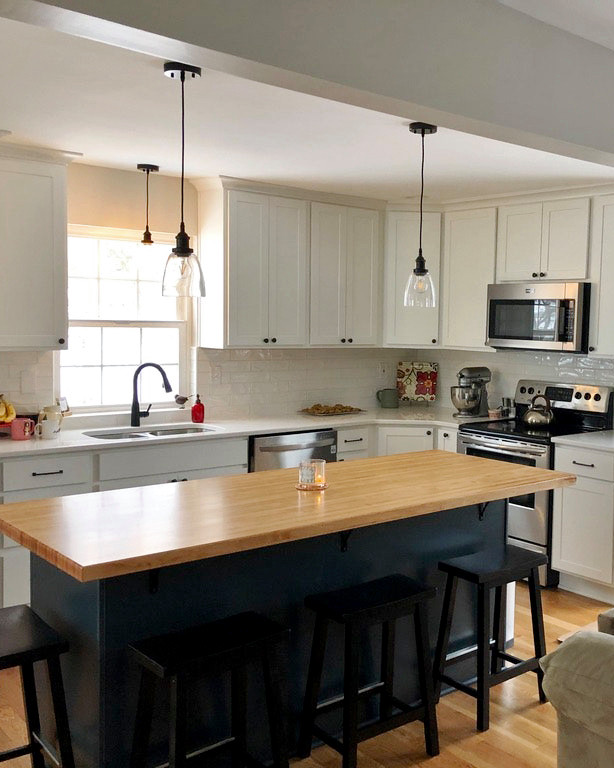 Country l-shaped medium tone wood floor and yellow floor eat-in kitchen photo in St Louis with a double-bowl sink, recessed-panel cabinets, white cabinets, wood countertops, white backsplash, subway tile backsplash, an island and yellow countertops