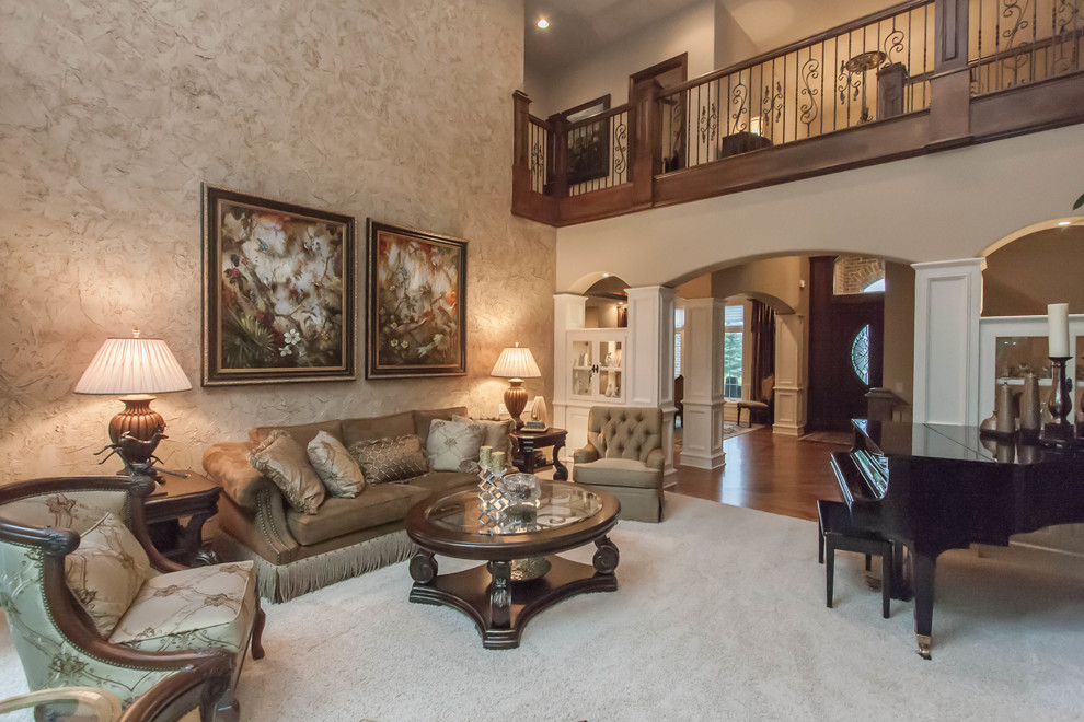 This is an example of a large traditional formal loft-style living room in Other with beige walls, carpet, a wood fireplace surround and no tv.