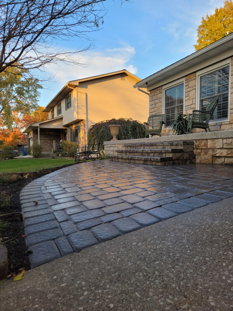 This is an example of a contemporary concrete paver porch design in Columbus.