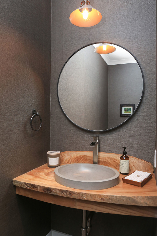 Photo of a small beach style powder room in San Francisco with grey walls, a vessel sink and wood benchtops.