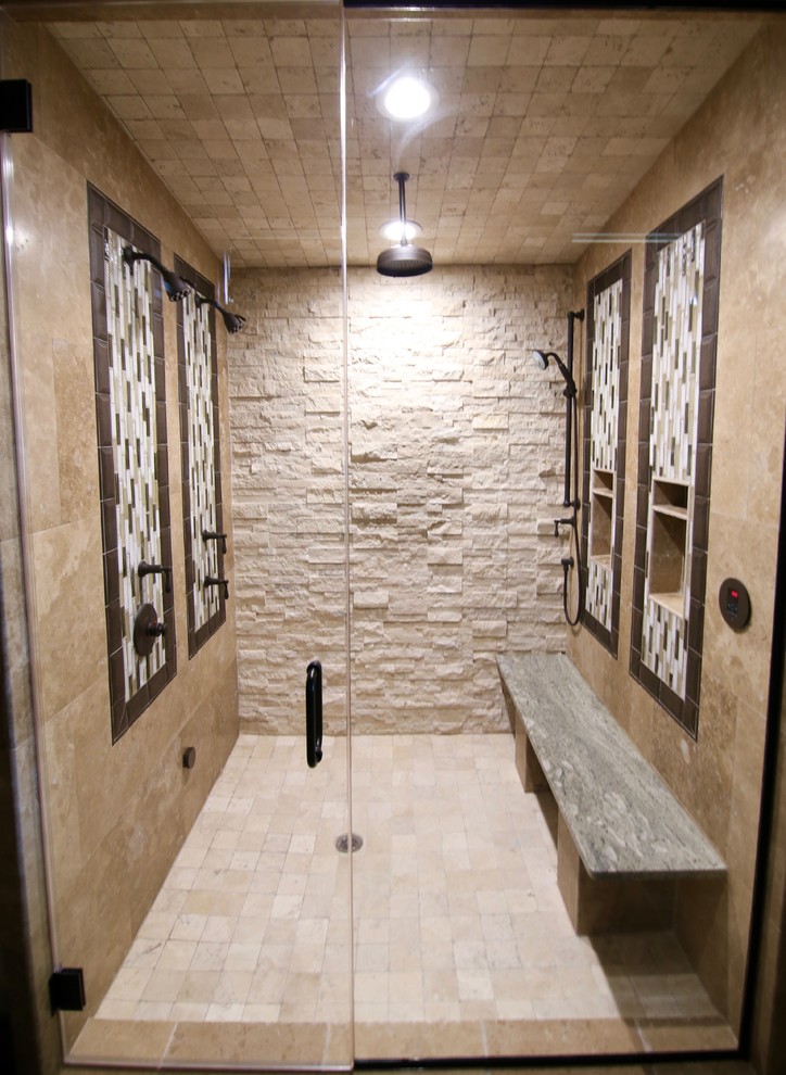 Large traditional master bathroom in Dallas with shaker cabinets, dark wood cabinets, a double shower, travertine floors, an undermount sink, granite benchtops, beige tile, stone tile, beige walls, brown floor and a hinged shower door.