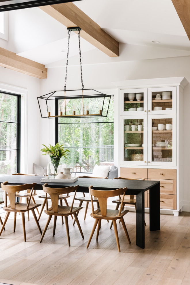 Example of a transitional light wood floor, beige floor and exposed beam dining room design in Salt Lake City with white walls