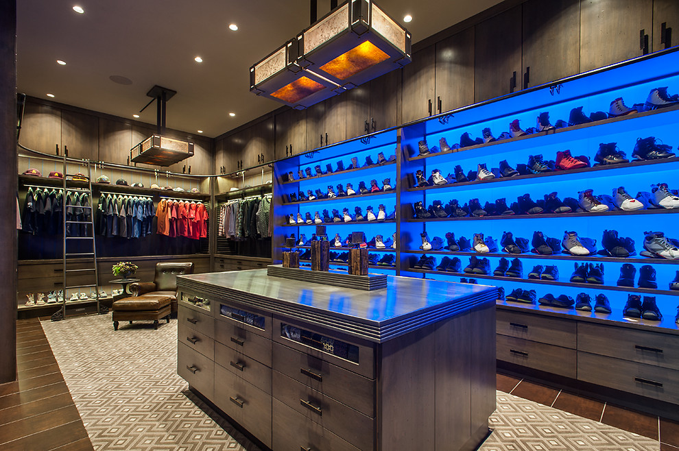 Design ideas for an expansive country men's walk-in wardrobe in Phoenix with flat-panel cabinets, distressed cabinets, porcelain floors and multi-coloured floor.