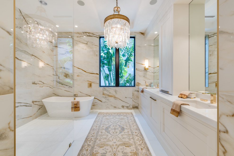 Inspiration for a transitional master bathroom in Miami with recessed-panel cabinets, yellow cabinets, a freestanding tub, a curbless shower, beige walls, an undermount sink, white floor and white benchtops.