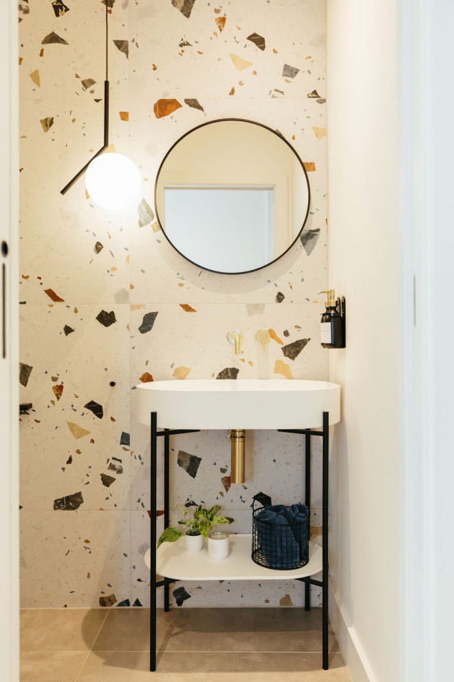 Small classic cloakroom in London with open cabinets, black cabinets, a wall mounted toilet, multi-coloured tiles, multi-coloured walls, terrazzo flooring, beige floors, feature lighting, a freestanding vanity unit and a vaulted ceiling.