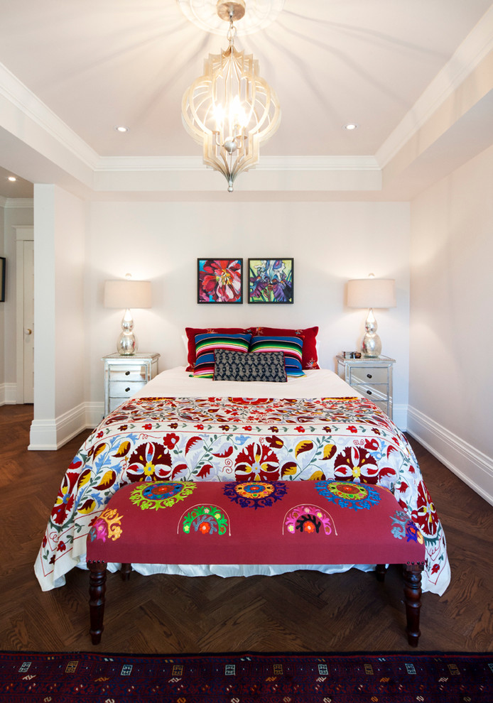 This is an example of an eclectic bedroom in Toronto with white walls and dark hardwood floors.