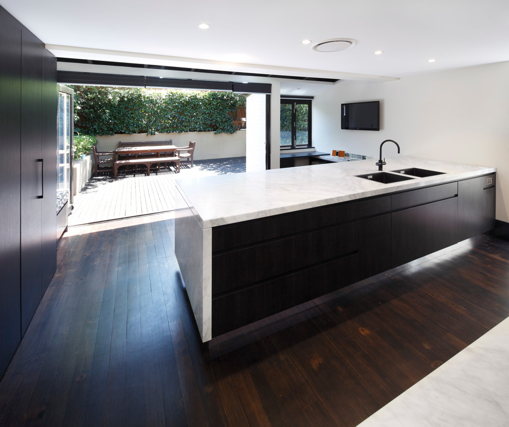 Design ideas for a contemporary single-wall kitchen pantry in Sydney with a double-bowl sink, flat-panel cabinets, dark wood cabinets, marble benchtops, stone tile splashback, stainless steel appliances, dark hardwood floors and with island.