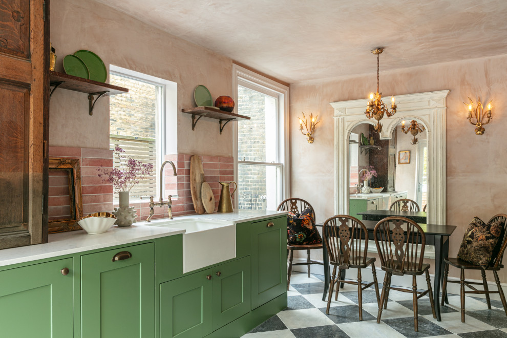 Inspiration for a mid-sized country galley eat-in kitchen in London with a farmhouse sink, shaker cabinets, green cabinets, quartzite benchtops, pink splashback, ceramic splashback, no island, multi-coloured floor and white benchtop.