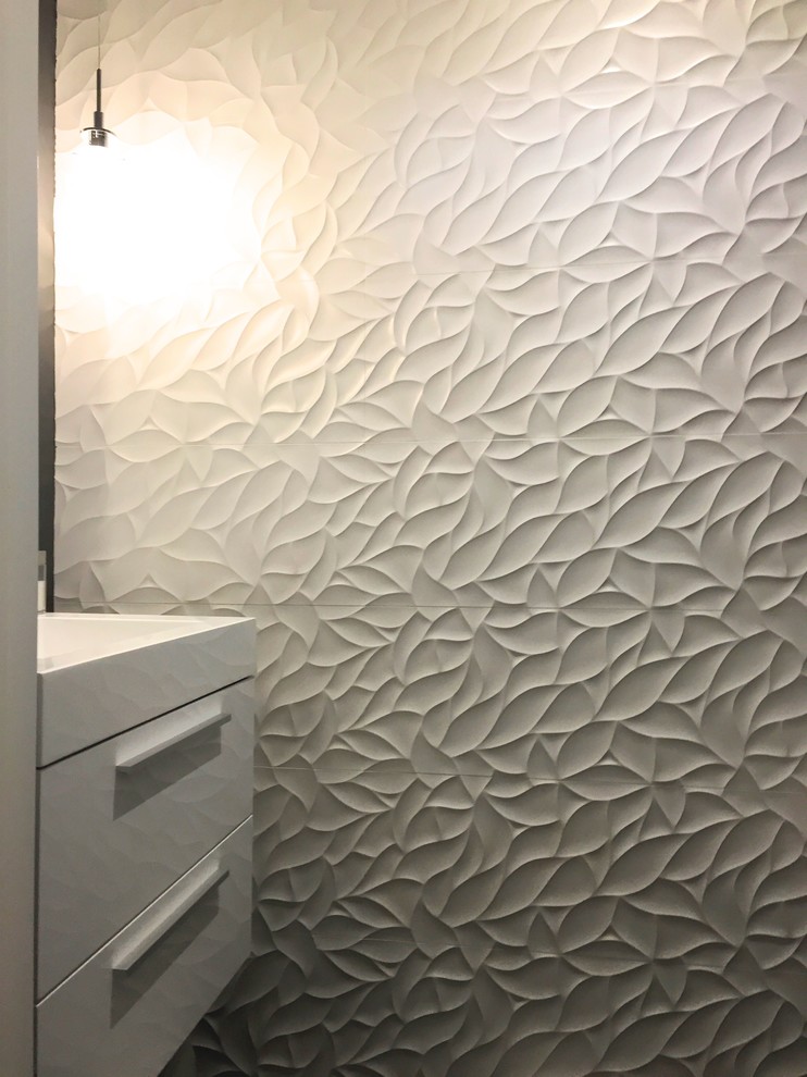 This is an example of a small transitional powder room in Toronto with flat-panel cabinets, white cabinets, white tile, grey walls, an integrated sink and solid surface benchtops.