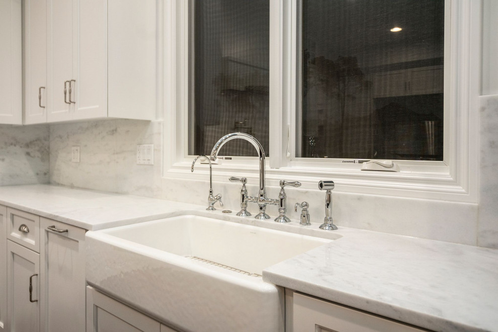 Example of a mid-sized l-shaped dark wood floor and brown floor eat-in kitchen design in Chicago with white cabinets, granite countertops, stainless steel appliances and an island